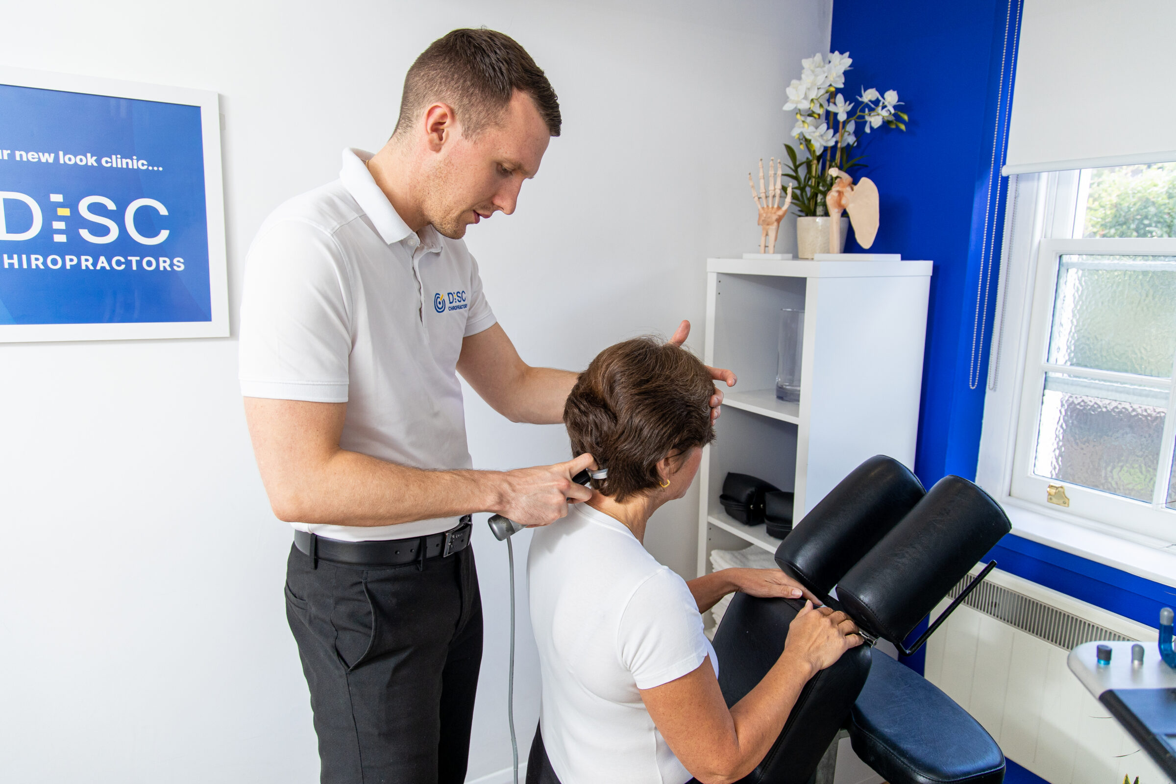 Patient receiving degenerative disc disease treatment from chiropractor with advanced technology.