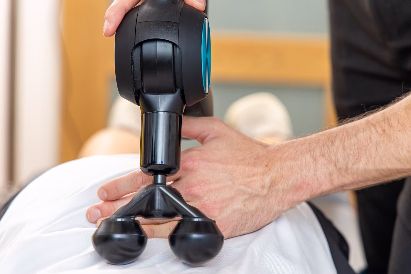 Patient receiving advanced soft tissue release treatment from a chiropractor at a Surbiton chiropractic clinic.